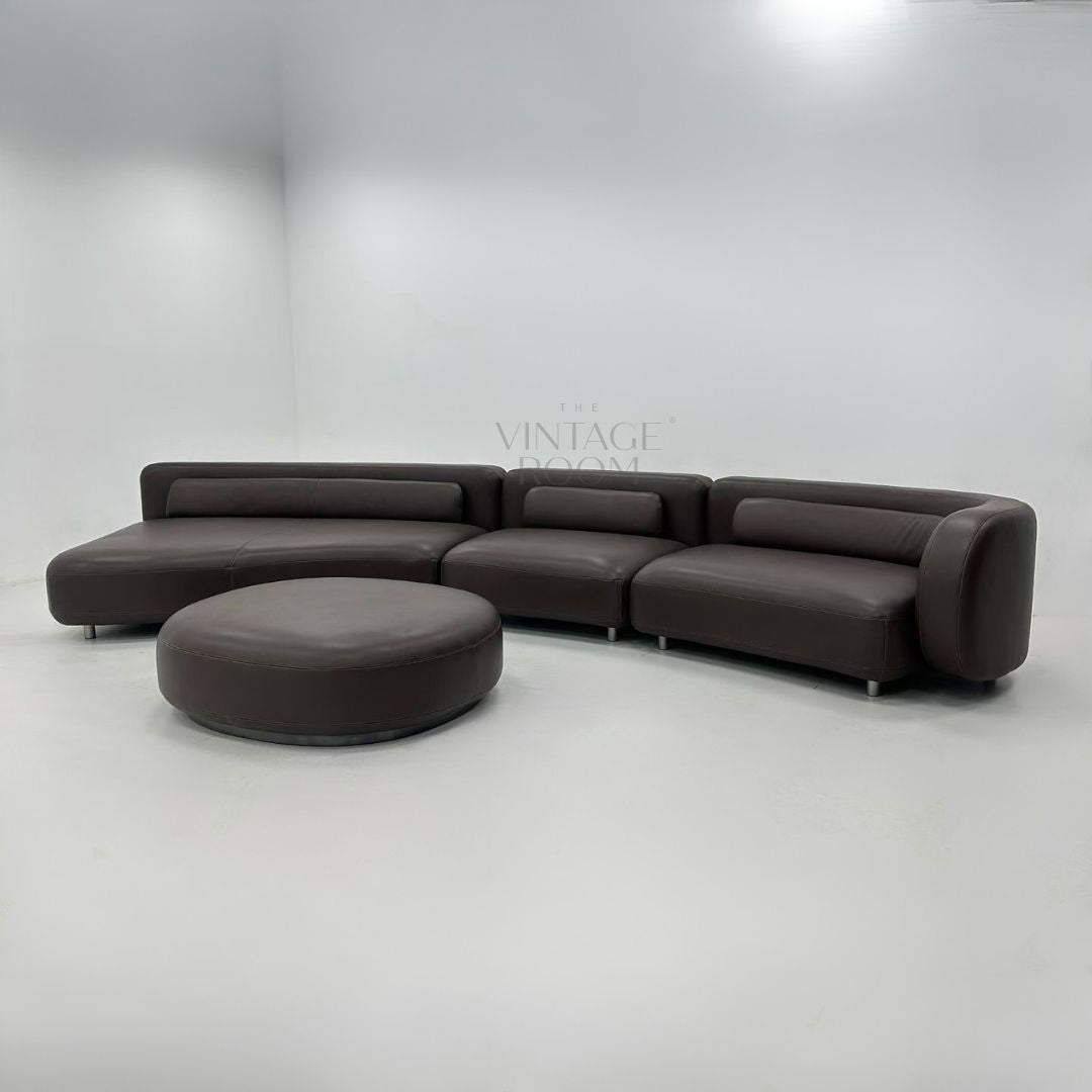 High-end designer leather sofa with ottoman in premium leather and modular lounge design